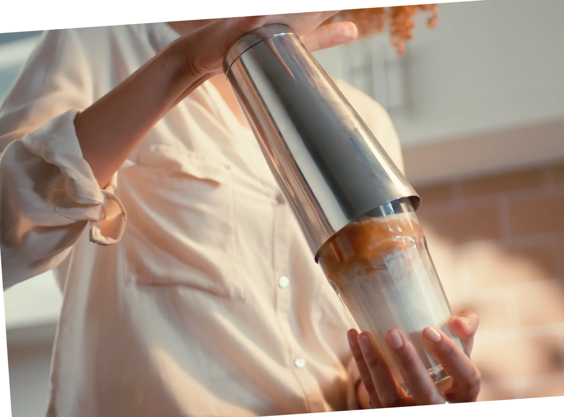Iced coffee being shaken in a glass