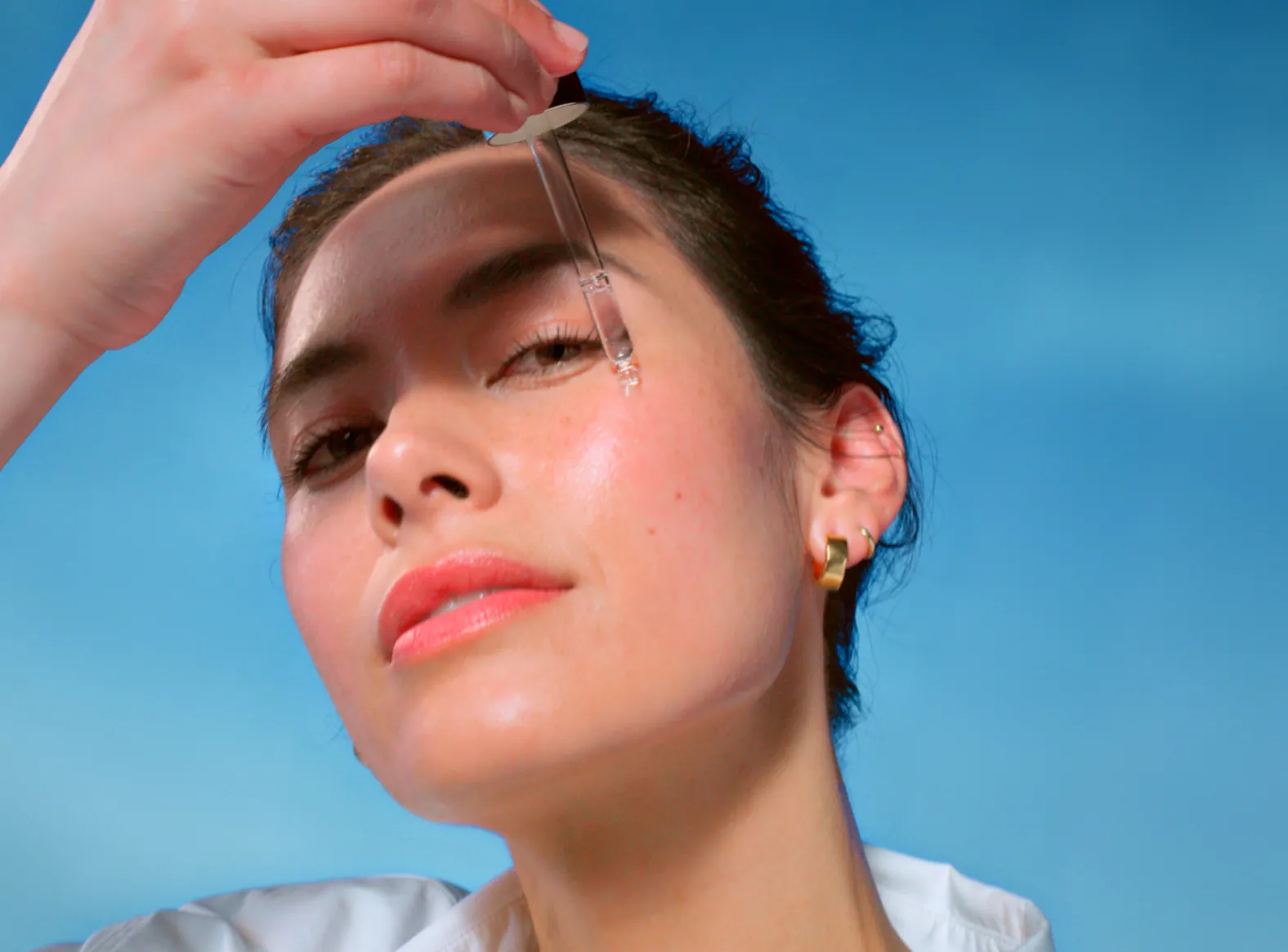 Model applying NIVEA serum with a dropper